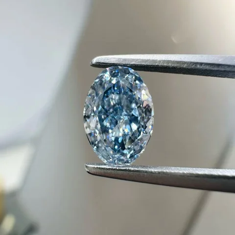 Blue oval diamond held in tweezers, supplied photograph