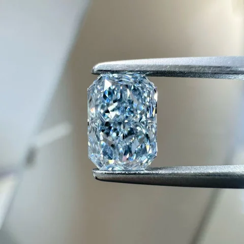 Blue radiant diamond held in tweezers, supplied photograph