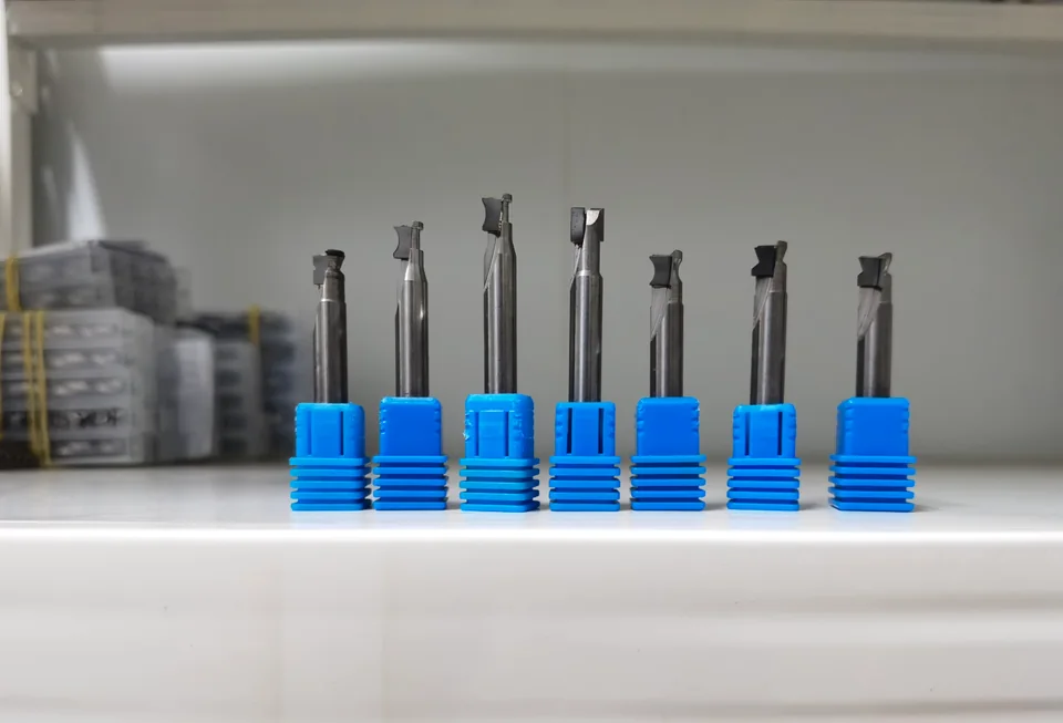 A row of seven DiamovaLab cutting tools showing different cutting profiles